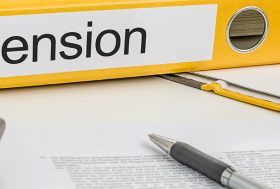 Papeles, calculadora y carpeta con la palabra “pension”